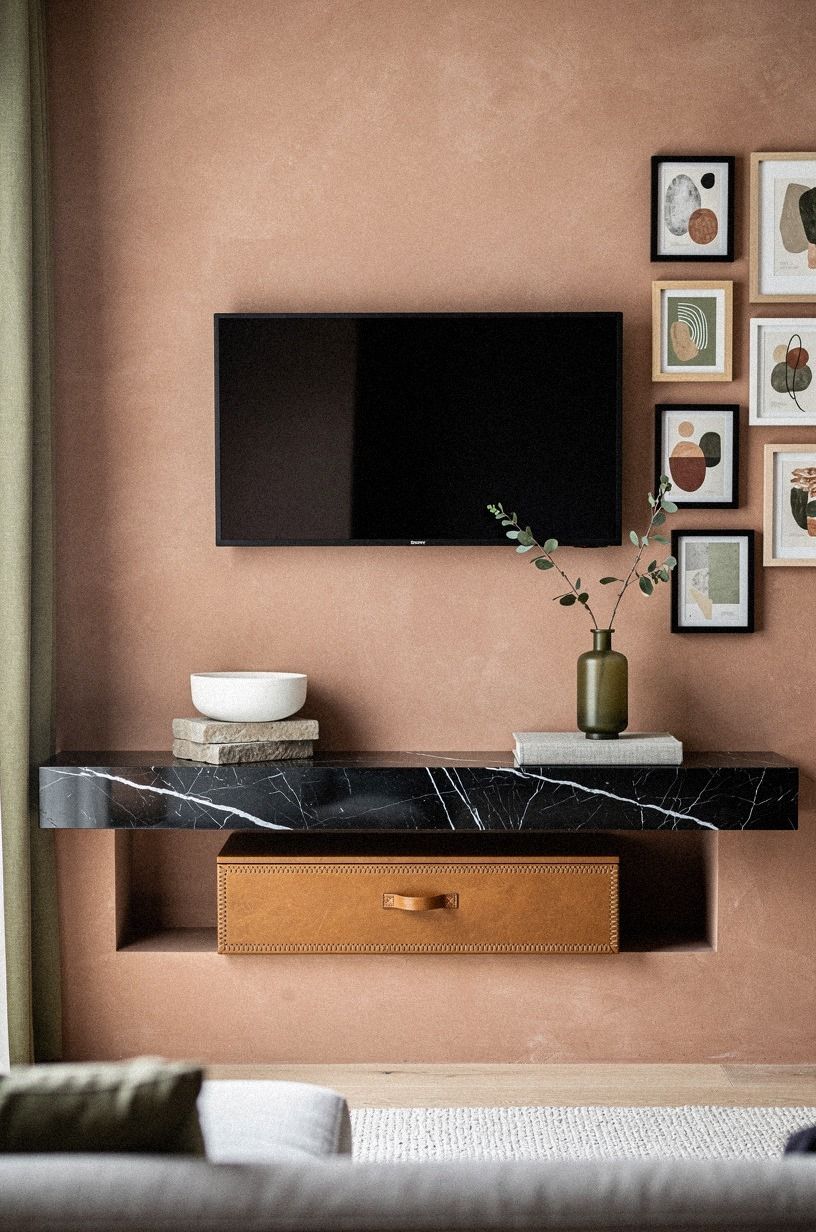 Cluster framed minis beside the television
