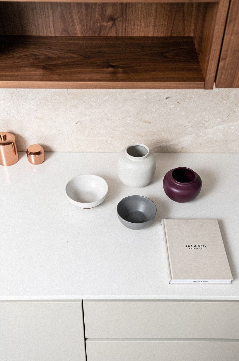 Run a limestone backsplash behind open shelves (Stone over tile?)