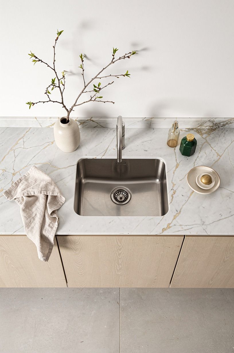 Frame the sink with a single branch vase