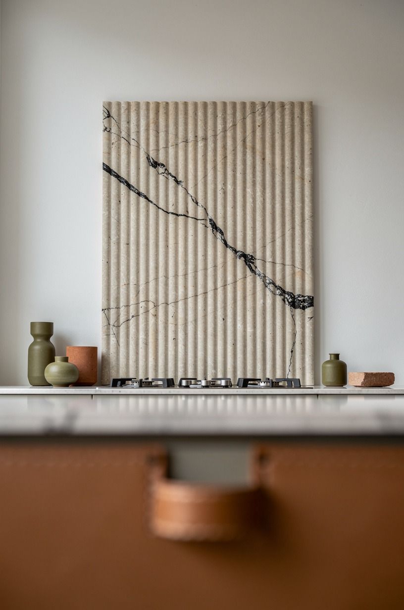 Install a fluted stone panel behind the cooktop