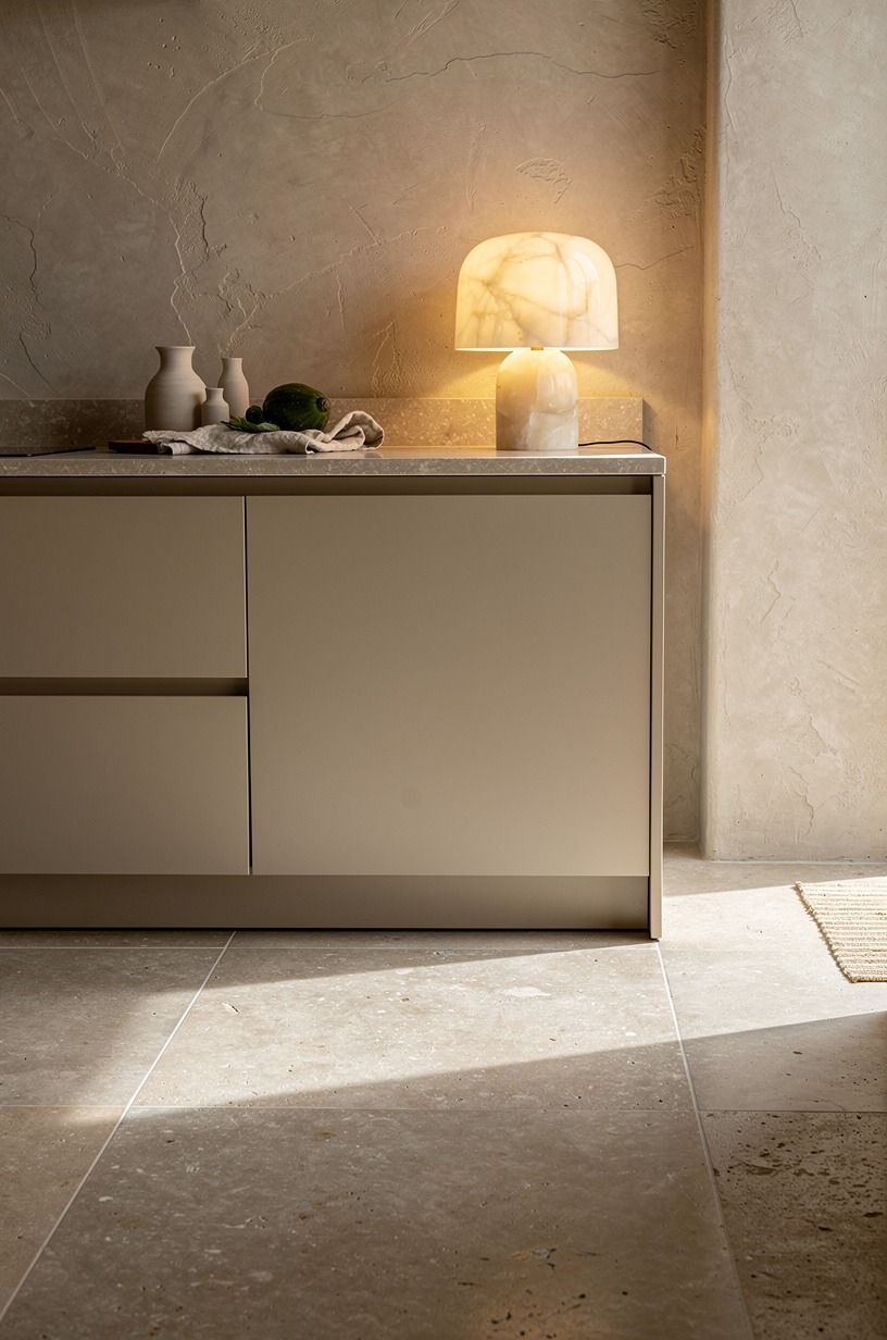 Choose matte limestone tiles for quiet warmth