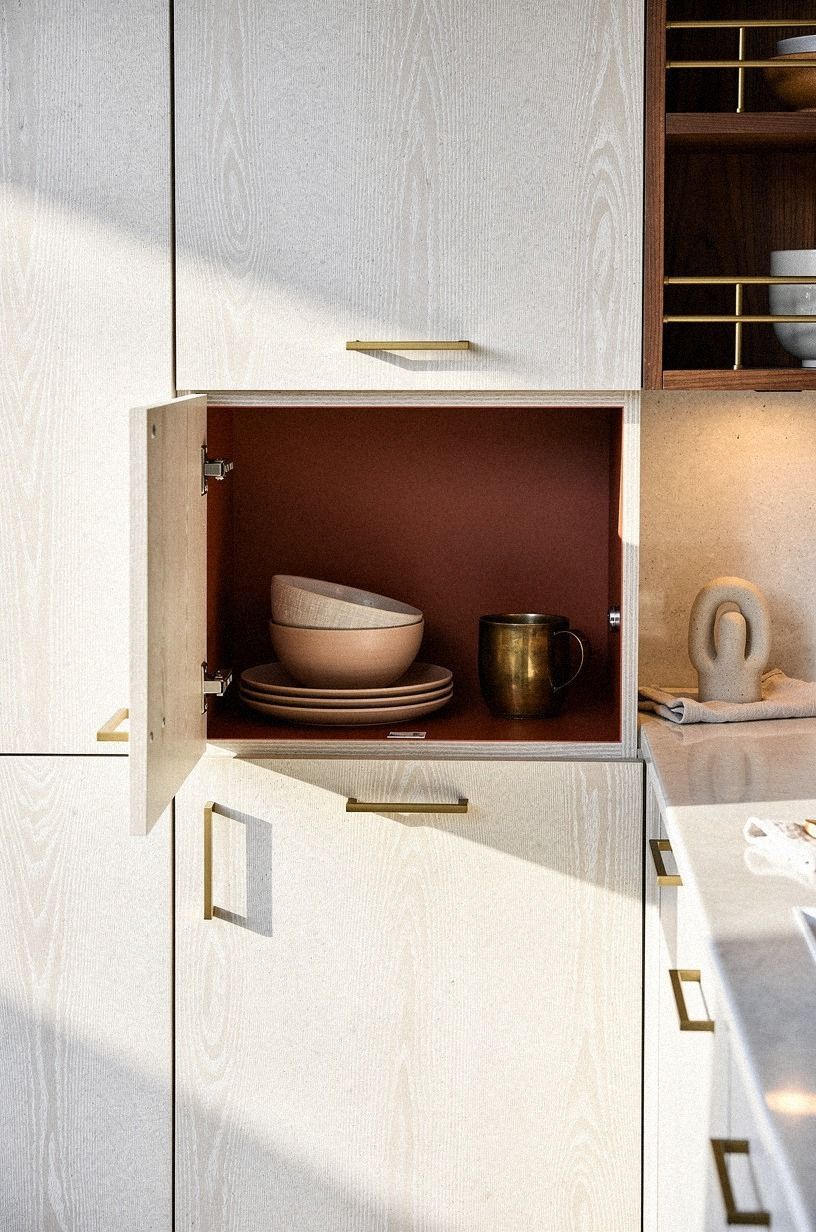 Paint the inside of one cabinet in your accent color