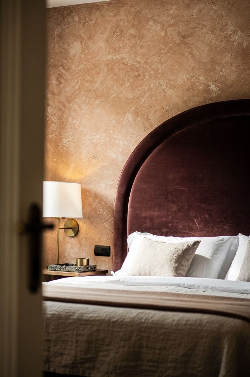 Anchor the bed with an arched velvet headboard