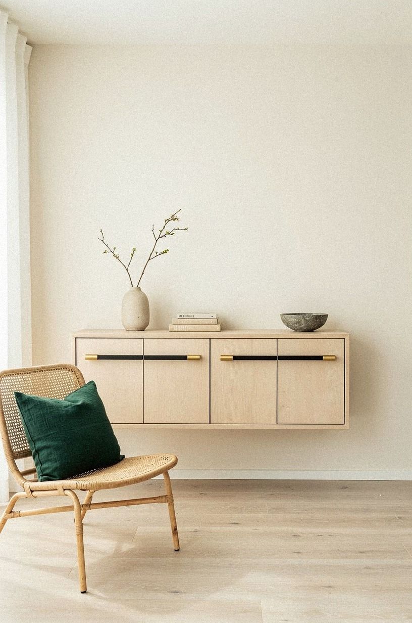 Span the full drawer with slim bar pulls on a blackened-steel console
