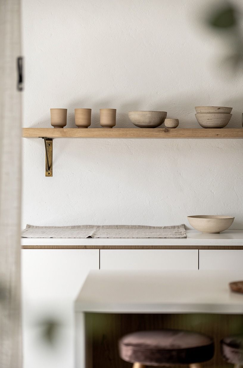 Float oak shelves above white countertops (The Air-Gap Rule)