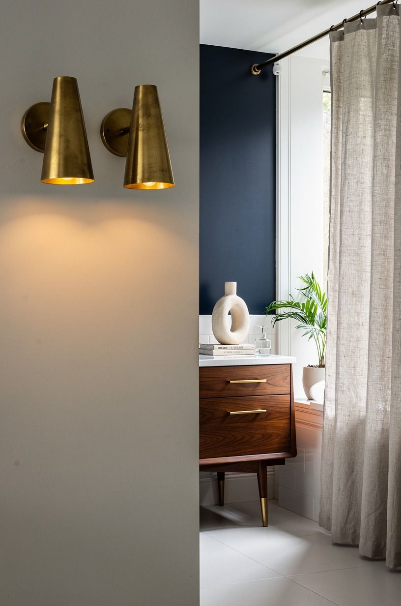 Hang a pair of unlacquered brass sconces at eye level