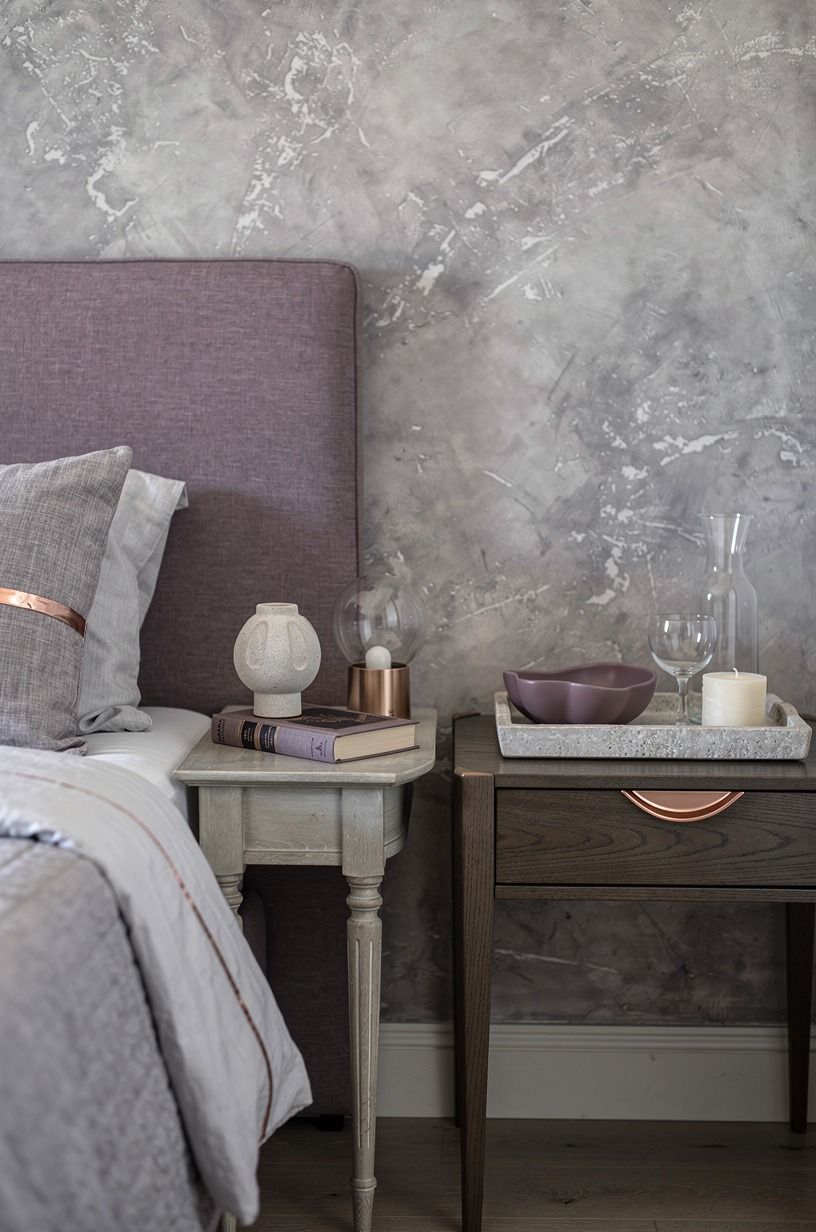 Frame the bed with mismatched bedside tables